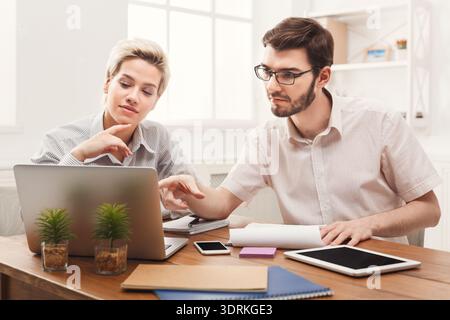 Professionals Work Together on a Project in a Modern Office Setting During the Day Stock Photo