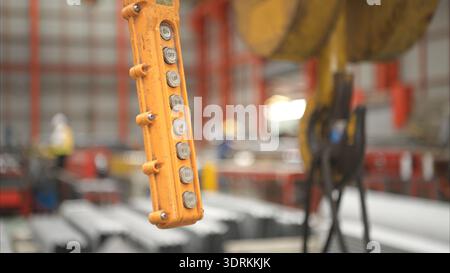 Close-up of industrial crane control panel with directional buttons inside a manufacturing warehouse Stock Photo