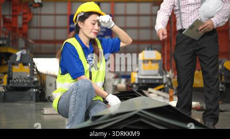 Senior engineers and young female workers are talking and inspecting steel plates Stock Photo