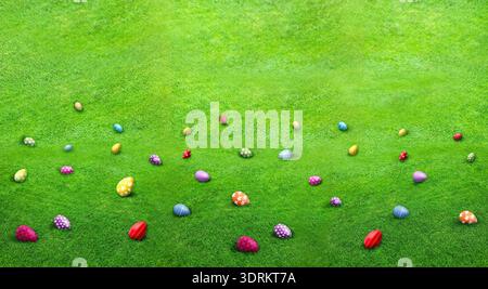 Easter eggs scattered in green grass. Holiday traditional game - egg hunt Stock Photo