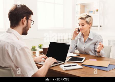 Business People Work Together During a Meeting in an Office Space Discussing Ideas and Projects Stock Photo