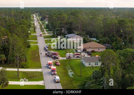 First responders arrived at fire alarm call ready to extinguish fire of burning house. Emergency service personnel responding to potential fire hazard Stock Photo