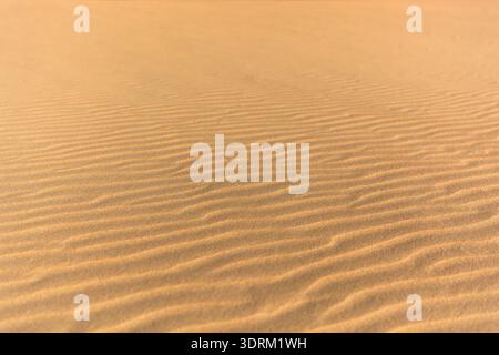 Wave patterns in the sand on the beach Stock Photo
