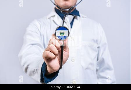 Doctor hands holding stethoscope with El Salvador flag. El Salvador health and care concept Stock Photo