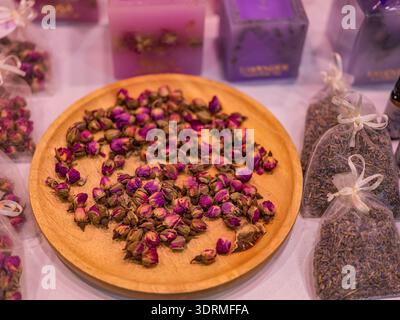 Dried rose buds on a wooden plate Stock Photo