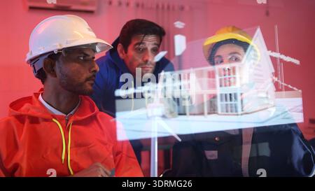 Engineers and industrial workers in safety uniforms discussing a construction Stock Photo