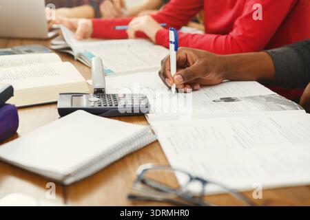 Students Engaged in Collaborative Study Session With Books and Notes on a Table Stock Photo