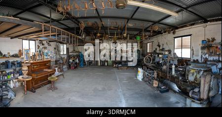 Almodovar del Rio, Spain - 15 Oct 23: Panoramic interior view of a workshop exhibit with vintage tools, machinery, and artifacts at the Ethnological M Stock Photo