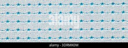 Red and white dotted pattern on knitted fabric background with repeating Stock Photo