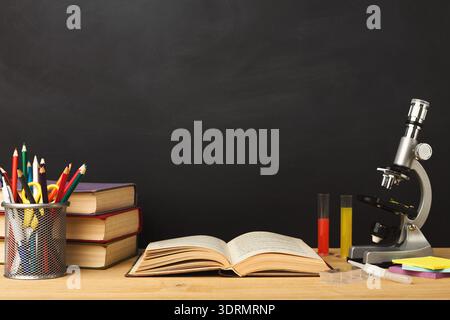 Collage of Science Tools and Books Arranged on a Wooden Table in a Classroom Setting Stock Photo