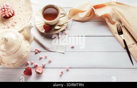 Cup of Tea With Cake and Strawberries on a Wooden Table With Light Fabric at Afternoon Stock Photo