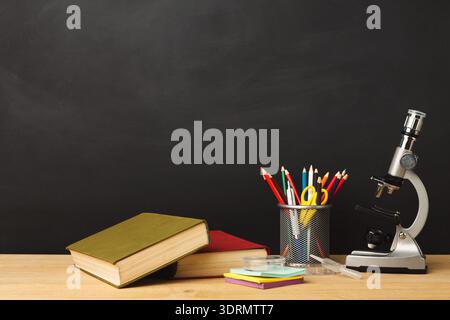 Collection of School Supplies and Educational Materials on a Desk With a Black Background Stock Photo