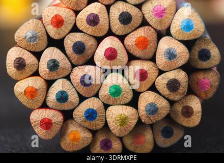 Colorful Collection of Pencils Arranged in a Circle on a Black Surface Stock Photo
