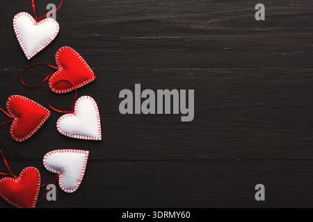 Hearts Made of Felt Are Arranged in a Collection on a Dark Wooden Table Stock Photo