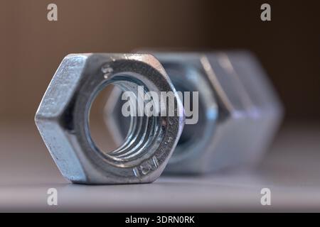 Detailed close up of chrome plated internal thread fasteners with shallow depth of field Stock Photo