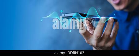 Close-up of hand using smartphone with holographic AI interface and audio waveform, representing voice recognition, cloud computing, IoT connectivity, Stock Photo