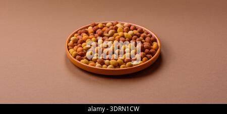 Food, nuts coated with salt and paprika, peanuts as a source of protein. Salted peanuts Stock Photo