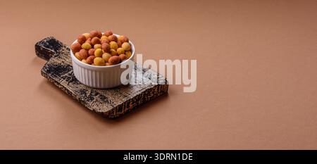 Food, nuts coated with salt and paprika, peanuts as a source of protein. Salted peanuts Stock Photo