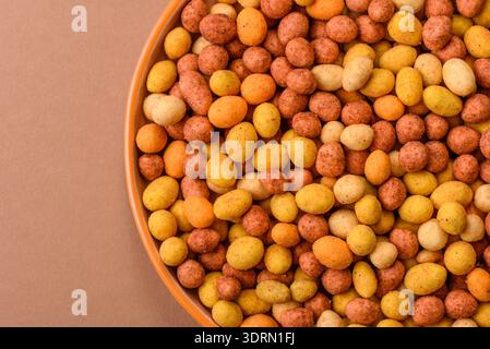 Food, nuts coated with salt and paprika, peanuts as a source of protein. Salted peanuts Stock Photo