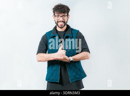 Person gesturing help with hands in nonverbal language. Smiling man showing help gesture with hands in sign language Stock Photo