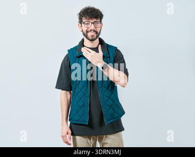 Young man making PLEASE gesture in sign language. Person gesturing PLEASE in nonverbal language Stock Photo