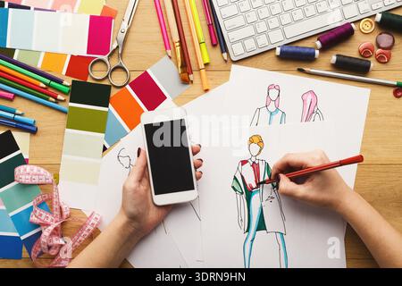 Creative Process in Fashion Design With Sketches and Tools on a Workspace Stock Photo
