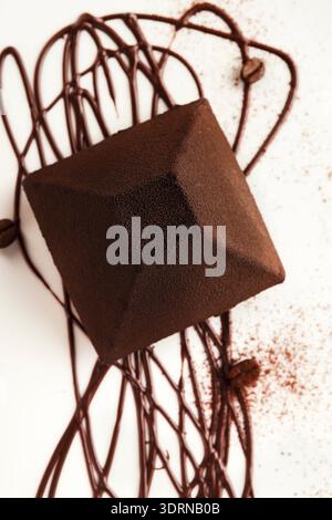 Collection of Chocolate Dessert Set on White Plate With Chocolate Drizzle and Coffee Beans Around Stock Photo