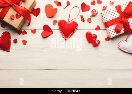 Collection of Red Hearts and Gifts Arranged on a Wooden Surface for Celebration Stock Photo