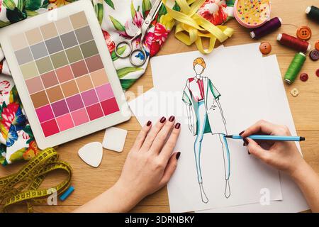 Creative Process of Designing a Fashion Collection in a Workspace Stock Photo