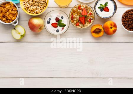 Breakfast Options Are Displayed in a Collage of Bowls and Fruits on a Wooden Table Stock Photo