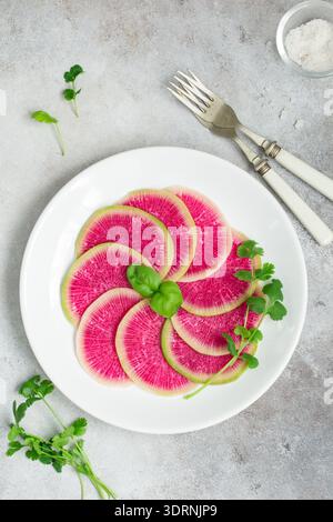 Sliced watermelon radish on white plate Stock Photo