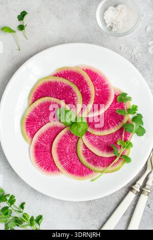 Sliced watermelon radish on white plate Stock Photo