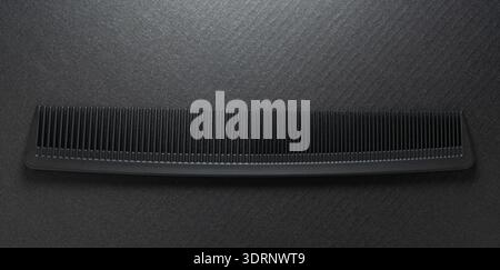 Close-up of hairdressing comb on a black background Stock Photo