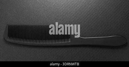 Close-up of hairdressing comb on a black background Stock Photo