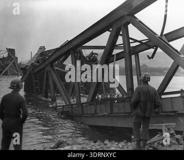Medics wait for casualties after the collapse of the Ludendorff Bridge into the Rhine on 17 March 1945. The Remagen Bridge (properly known as the Ludendorff Bridge) was one of only four bridges across the Rhine still standing in 1945. The German attempt to destroy it failed and the bridge was captured by the US Army. It collapsed a couple of weeks later but by that time several other bridges had been built by engineers. Stock Photo