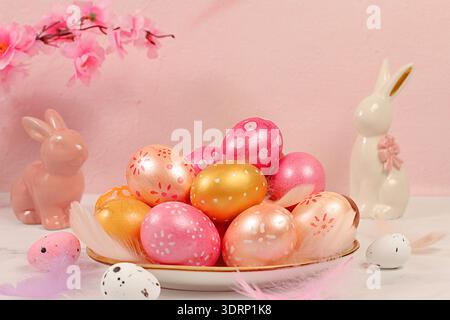 Beautiful Easter banner with decorated festive eggs, sakura and cherry blossom branches, rabbits and feathers. Happy Easter conc Stock Photo