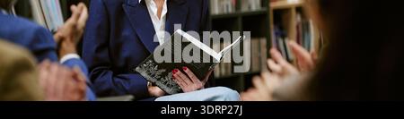 Middle Aged Woman Reading Book during Presentation in Library Stock Photo