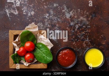 Fresh Vegetables and Sauces Arranged on a Wooden Table for Meal Preparation Stock Photo