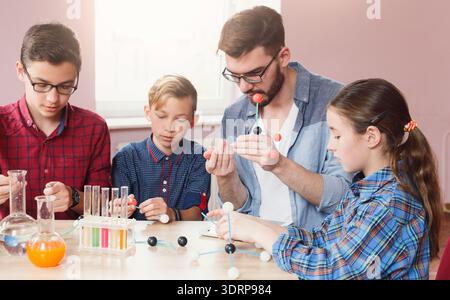 Students Learn About Molecules Through Hands-On Activity in a Classroom Setting Stock Photo