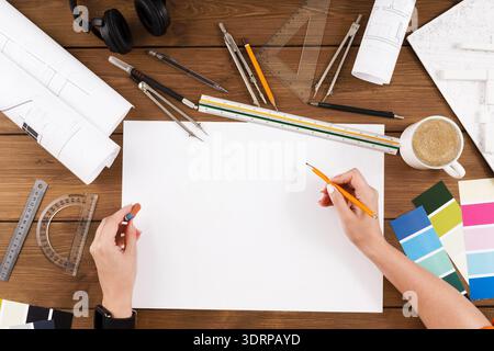 Creative Process Involves Sketching Ideas on Blank Paper With Tools for Design and Planning Stock Photo