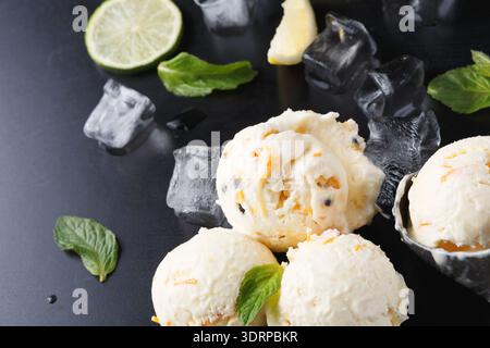 Ice Cream Served With Mint, Lime, and Ice Cubes on a Black Surface for a Refreshing Dessert Stock Photo