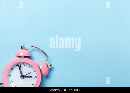 Vintage alarm clock Isolated on blue pastel background Stock Photo