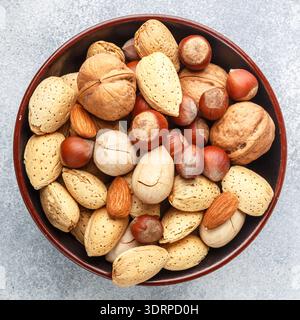 Tasty and healthy assorted nuts in the peel-almonds, hazelnuts, pecans, walnuts. Gourmet snack. Proper food. Selective focus Stock Photo