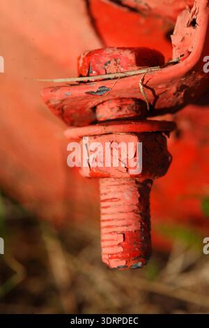 Red metal screw and nut Stock Photo