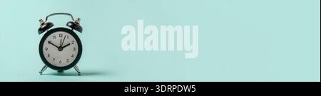 Simply minimal design ringing twin bell vintage classic alarm clock Isolated on blue pastel background. Rest hours time of life Stock Photo