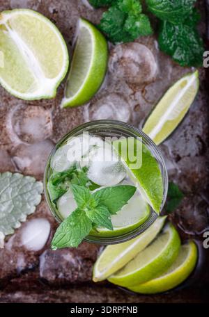 Mojito cocktail or lemonade with lime, mint and ice cubes. Traditional summer refreshing drink. Selective focus Stock Photo