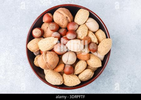 Assorted nuts in the peel-almonds, hazelnuts, pecans, walnuts. Gourmet snack. Healthy food. Selective focus Stock Photo