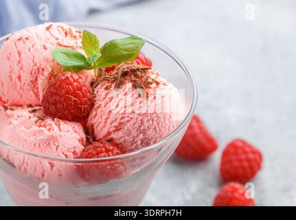 Homemade raspberry ice cream with chocolate and mint. A refreshing dessert for gourmets. Selective focus Stock Photo