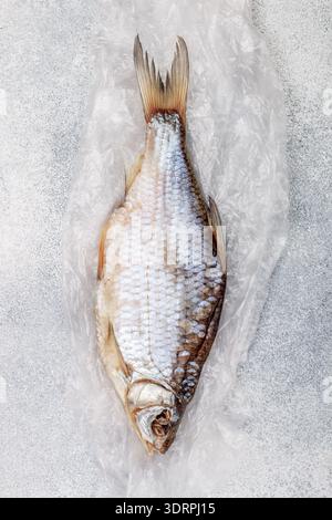Dried salted fish on grey concrete background.  Traditional Russian appetizer. Selective focus Stock Photo