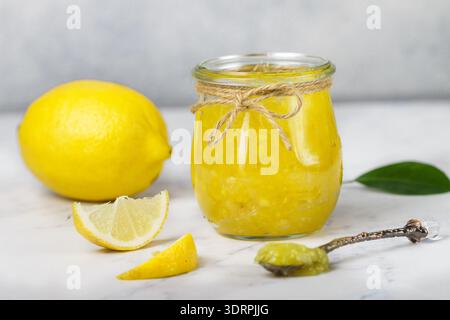 Homemade delicacy natural lemon jam (marmalade, Kurd) in a glass jar. Dessert. Selective focus Stock Photo